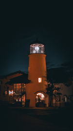 Lighthouse against sky at night