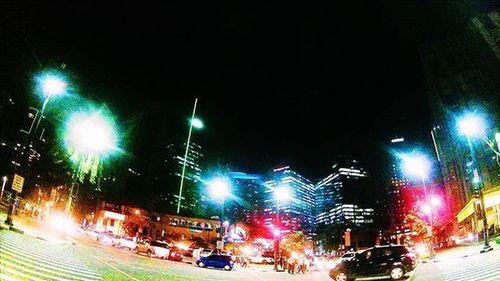 Illuminated city street at night