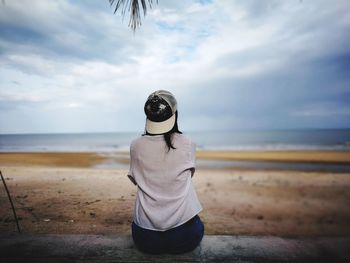 Rear view of man standing on beach