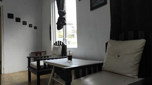 Empty chairs and table against wall at home