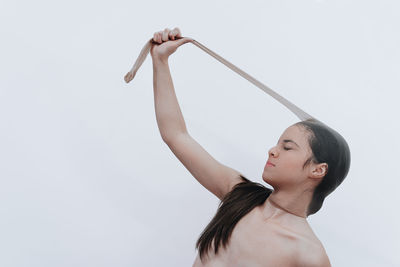 Woman looking away against white background