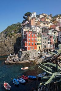 Buildings at manarola against clear blue sky