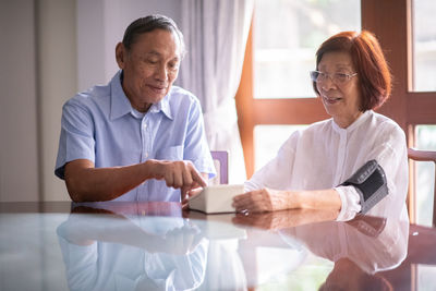 Senior couple sitting on table