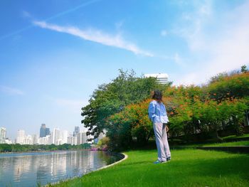 Man standing by plants against sky