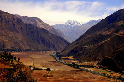 Scenic view of mountains against cloudy sky