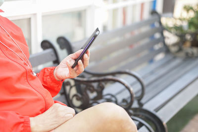 Midsection of man using mobile phone