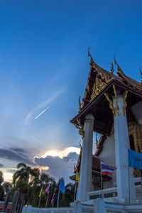 Low angle view of illuminated tower against blue sky