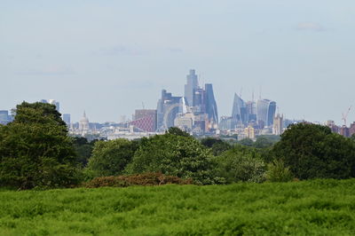 Buildings in city against clear sky