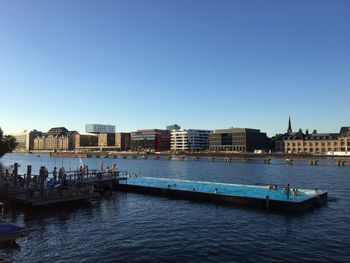 View of buildings against clear blue sky