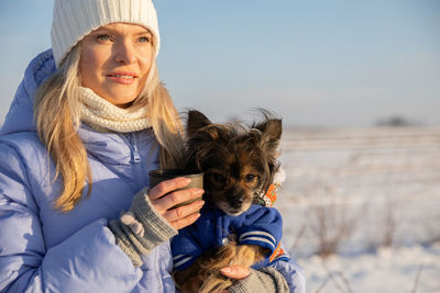 Portrait of young woman with dog