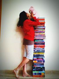 Full length of a young woman standing on stack