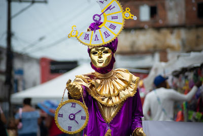 People wearing venetian carnival-style masks are seen during the carnival in the city of maragogipe,