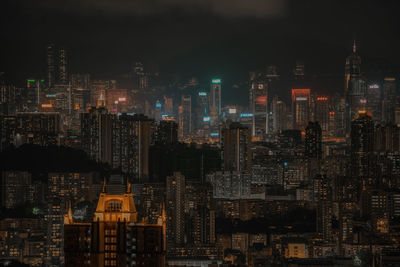 High angle view of illuminated modern buildings against sky at night