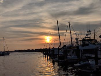 Sailboats in marina at sunset