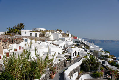 High angle view of town by sea against clear sky