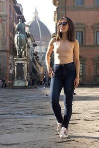 Portrait of woman smiling with sunglasses unfocused background at florence, italy. 50mm lens