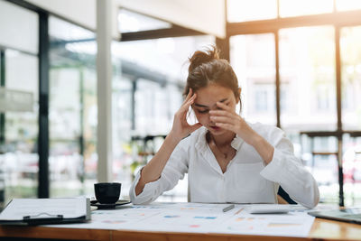 Businesswoman talking on phone in office