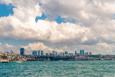 Panoramic view of sea and buildings against sky