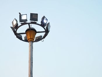 Low angle view of illuminated street light against clear sky