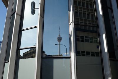 Reflection of communications tower in city