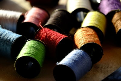 Close-up of colorful spools of thread on fabric