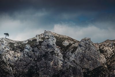 Low angle view of rocky mountains against sky
