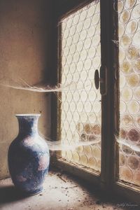 Close-up of vase on window