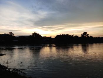 Scenic view of lake against orange sky