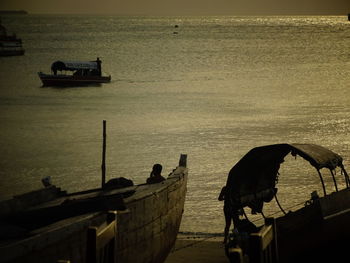 High angle view of silhouette people on boat against sky