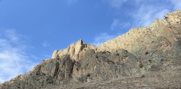 Low angle view of rock formations against sky