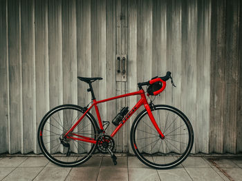 Bicycle parked against wall