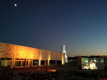 Illuminated built structure against clear sky