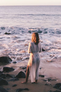 Rear view of woman looking at sea shore
