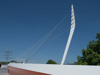 Low angle view of bridge against clear blue sky