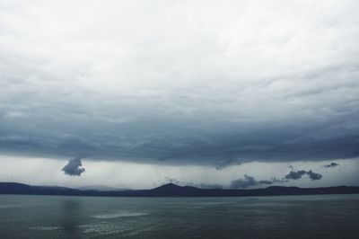 Scenic view of sea against cloudy sky