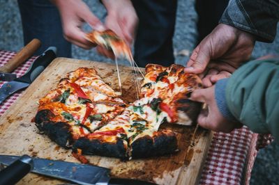 Friends having pizza on table