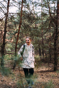 Portrait of man standing in forest