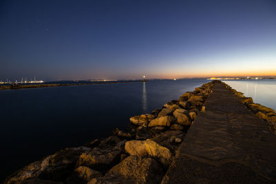 Scenic view of sea against clear sky at night