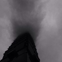 Low angle view of building against cloudy sky