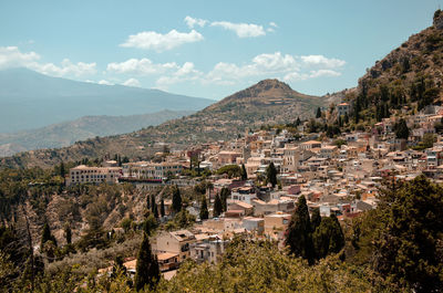 High angle view of townscape and mountains against sky