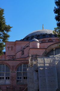 Low angle view of building against clear blue sky