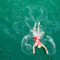 High angle view of woman swimming in sea