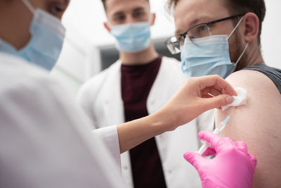 Midsection of doctor holding dentures