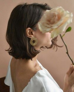 Close-up of girl blowing roses