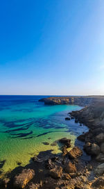 Scenic view of sea against clear blue sky