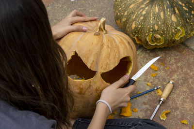 Close-up of woman with pumpkin