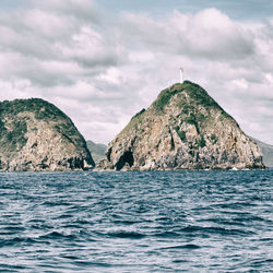 Scenic view of sea and mountain against sky