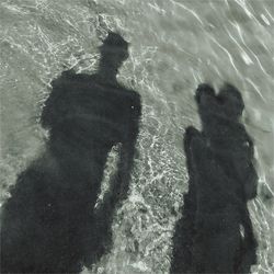 Shadow of man on sea shore
