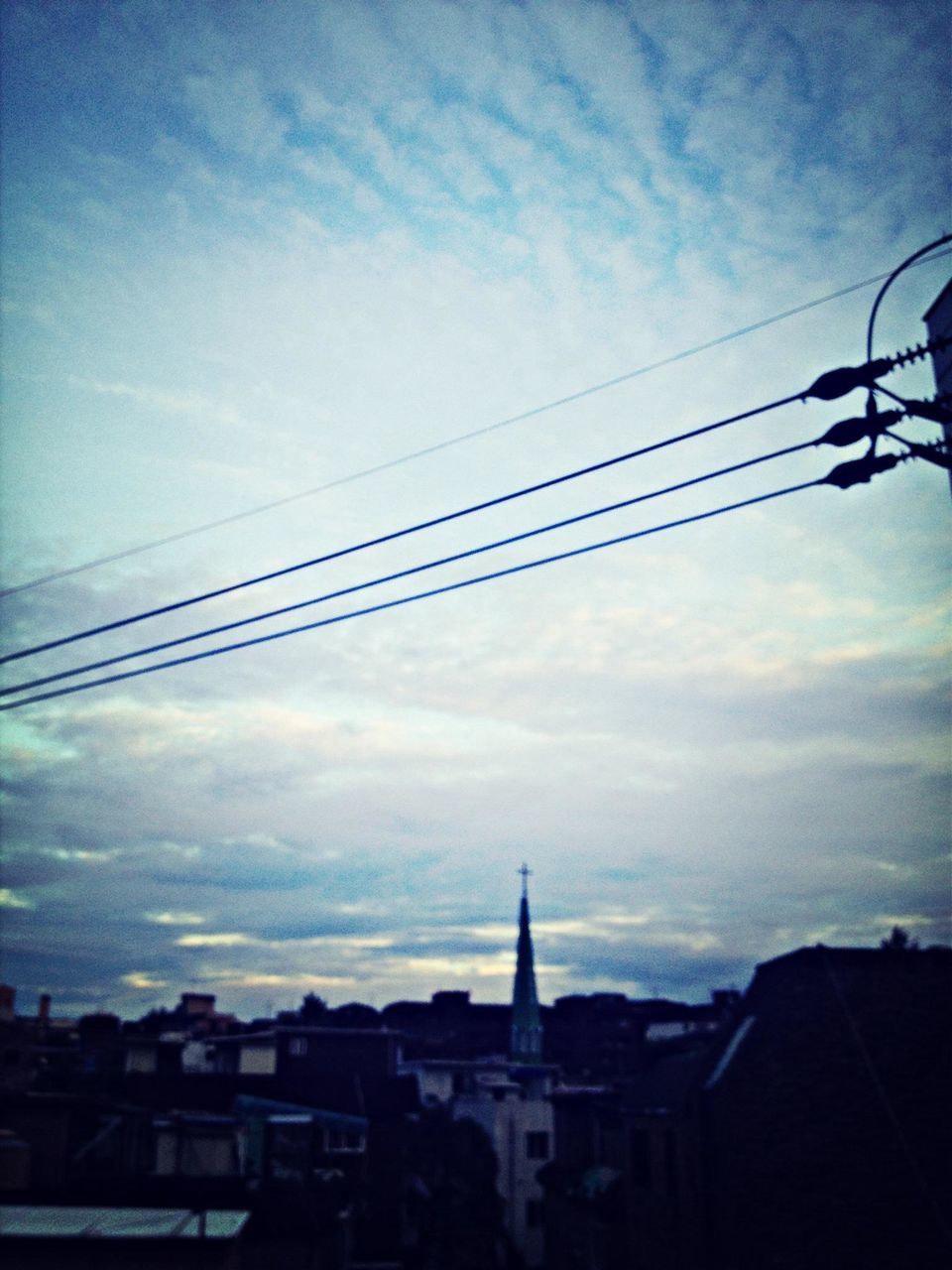 sky, architecture, built structure, building exterior, cloud - sky, power line, cable, low angle view, cloudy, cloud, connection, silhouette, sunset, house, electricity pylon, residential structure, power supply, electricity, residential building, city