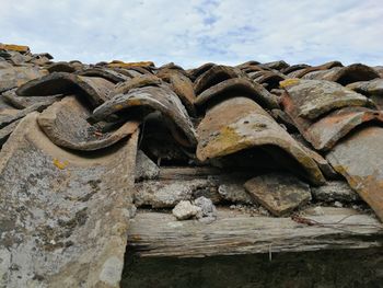 Low angle view of old rusty metallic structure against sky